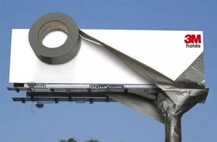 Billboard designed as a giant roll of duct tape partially unrolled, showcasing a creative and funny billboard concept.