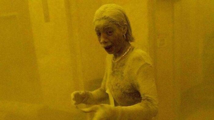 Person covered in dust or ash inside a yellow-hued environment, illustrating resilience in inspiring facts better than news.