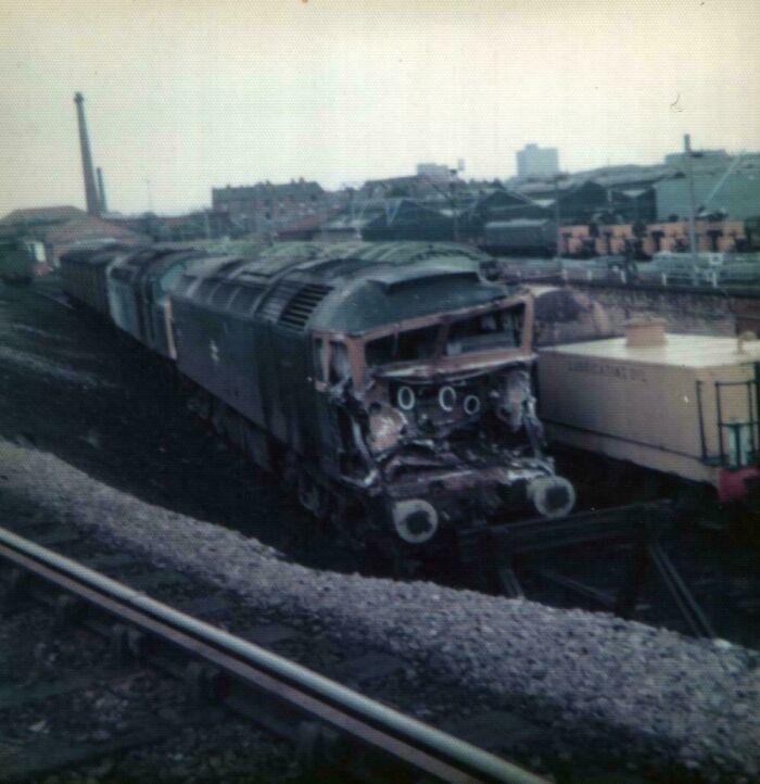 Old damaged train resting on railway tracks in an industrial area, illustrating inspiring facts better than watching news.