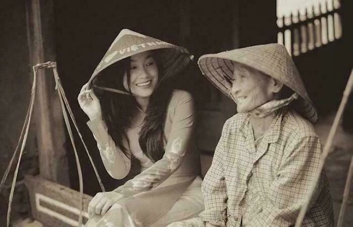 Two women wearing traditional hats sharing a joyful moment, inspiring facts capturing genuine happiness and culture.