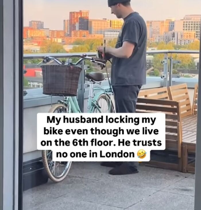 Man locking bike on a balcony in London, showing humor about trust and safety in great London memes.