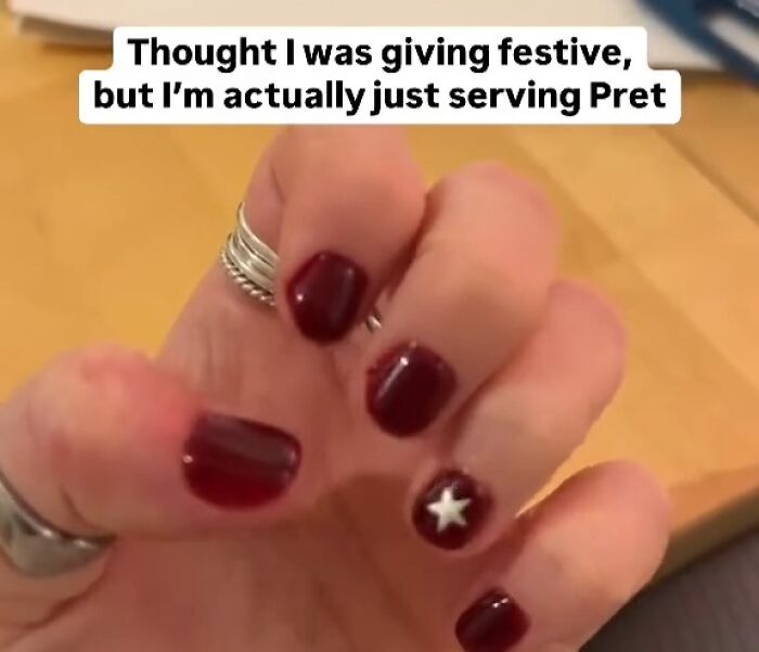 Close-up of a hand with dark red nails and a white star, featuring a humorous meme about Great London memes UK humor.