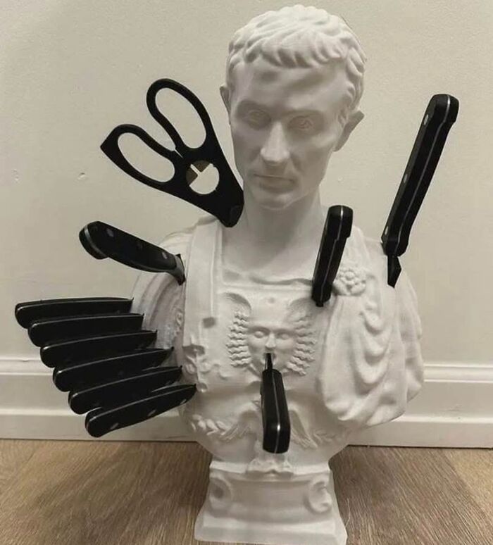 White bust sculpture turned into a quirky knife and scissors holder, showcasing weirdest purchases people would make.