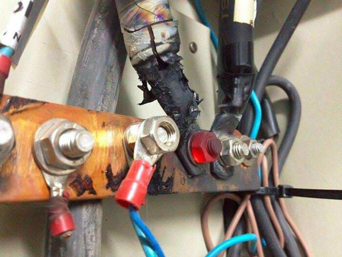 Corroded and poorly soldered electrical connections with damaged insulation and tangled wires creating a hazardous setup.