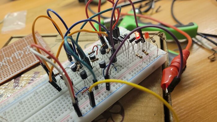 Breadboard circuit with multiple wires and components connected, illustrating soldering and electronics handling challenges.