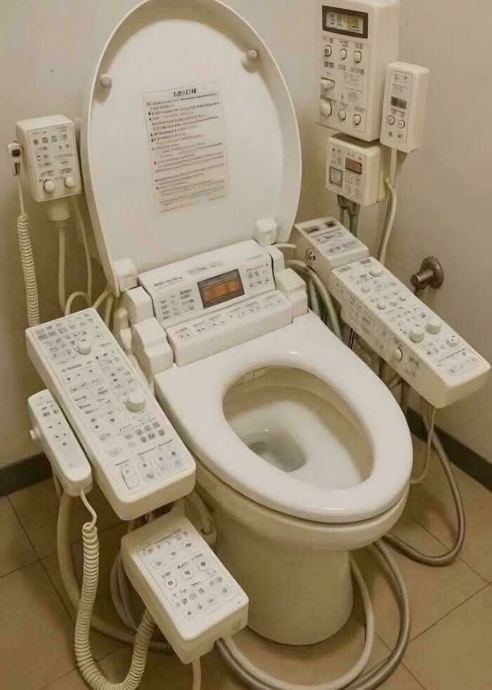 Toilet equipped with multiple electronic control panels, illustrating painful pics of people handling electronics the wrong way