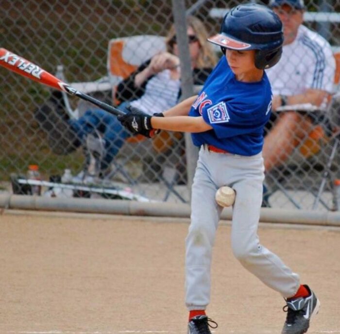 Young baseball player just before impact with the ball showing the moment split seconds before disaster struck