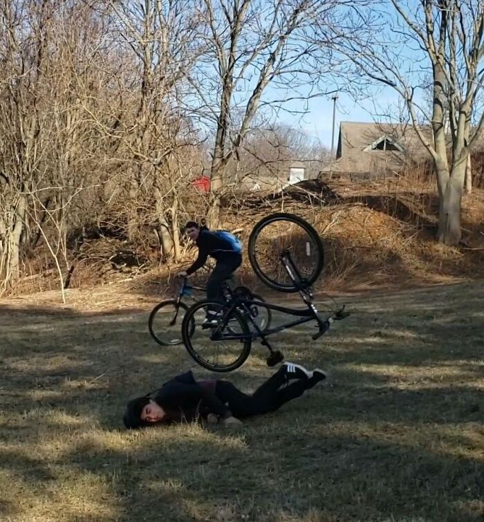 Person falling off bike in a hilarious split second before disaster hits in an outdoor park setting.