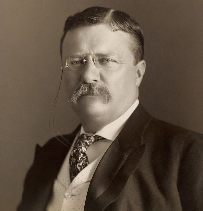 Sepia-toned portrait of a historical figure with glasses and mustache, related to famous historical quotes.