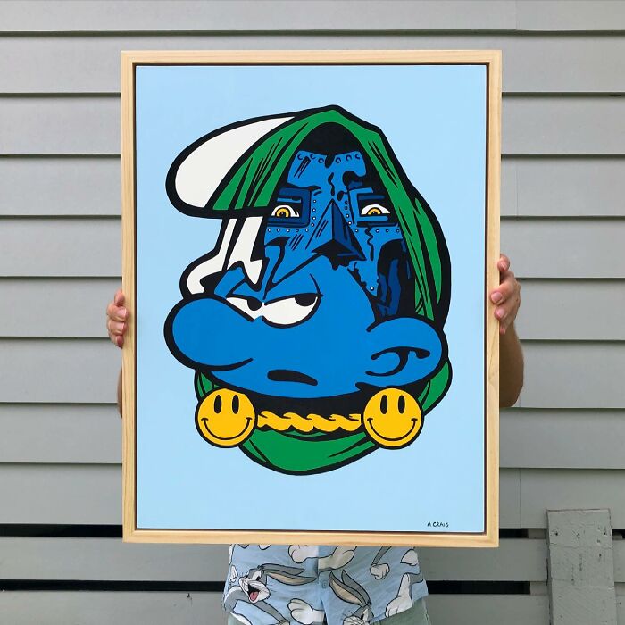 Framed pop culture and cartoon character mash-up art featuring a blue face with green and yellow accents held outdoors.