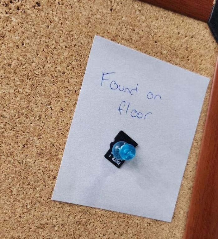 Micro SD card pinned to a corkboard with a note saying found on floor, illustrating electronics handled the wrong way.