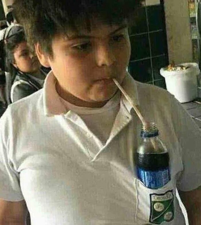 Child with an inventive hack sipping soda through a straw attached to the shirt pocket, showcasing kids surprised parents inventions.