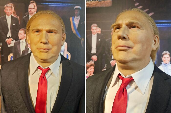 Wax figure of a man in a suit with a red tie, captured in a weird and oddly blessed or cursed photo.
