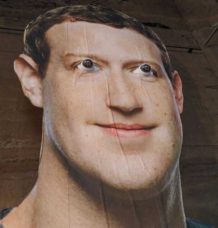 Distorted giant face cutout with weird eyes creates a cursed and blessed look in an unusual weird picture.