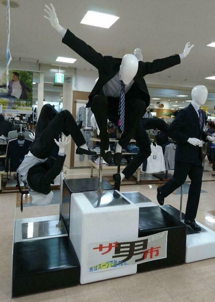 Mannequins in suits posed in weird, dynamic positions inside a store, creating a blessed and cursed vibe.