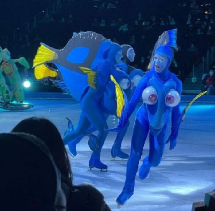 Performers in weird blue fish costumes ice skating during a show, a bizarre and cursed moment caught on camera.