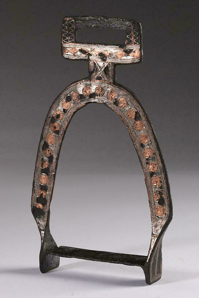 Medieval horse stirrup with decorative patterns, showcasing craftsmanship appreciated by medieval history enthusiasts.