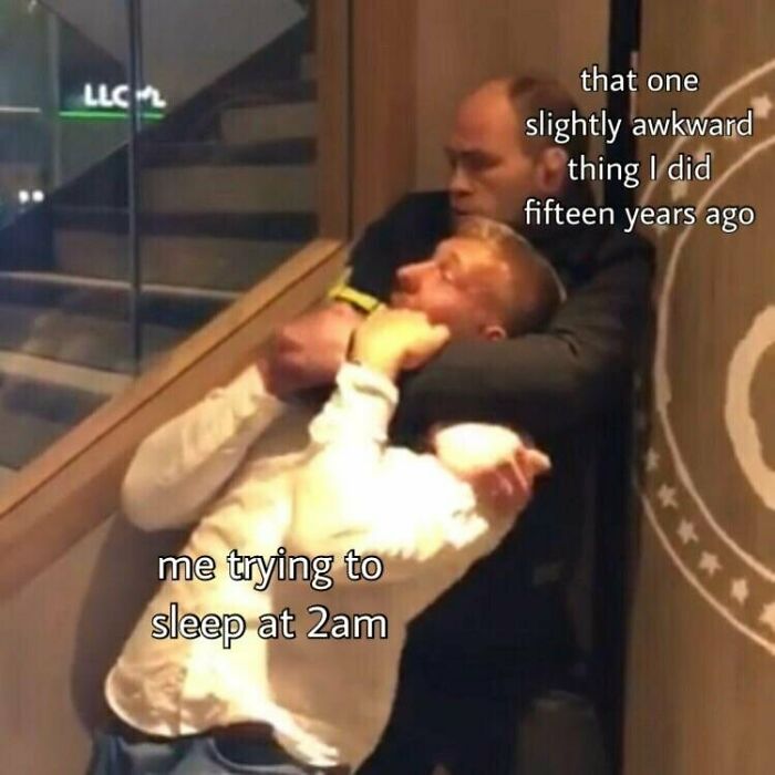 Two men in an awkward hold, representing funny insomnia memes about racing thoughts keeping someone awake at 2am.