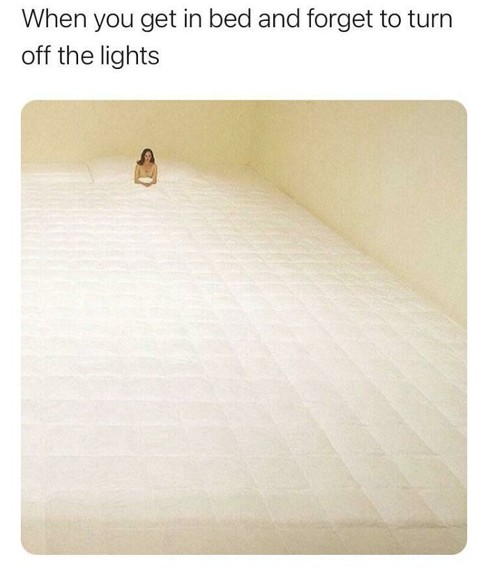 Person sitting on an oversized bed, illustrating funny insomnia memes about struggling to sleep when lights are left on.
