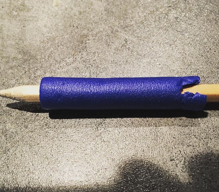 Blue 3D printed grip on pencil, showcasing a creative kids invention with high IQ innovation and surprising design.