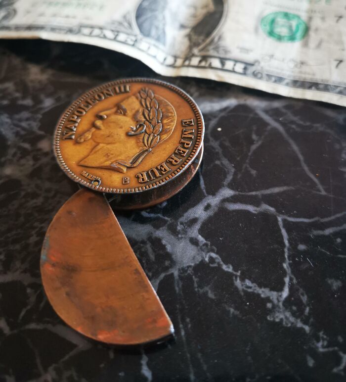 Old coin with a carved blade attached, found but with no clue what it is, shared for internet identification help.