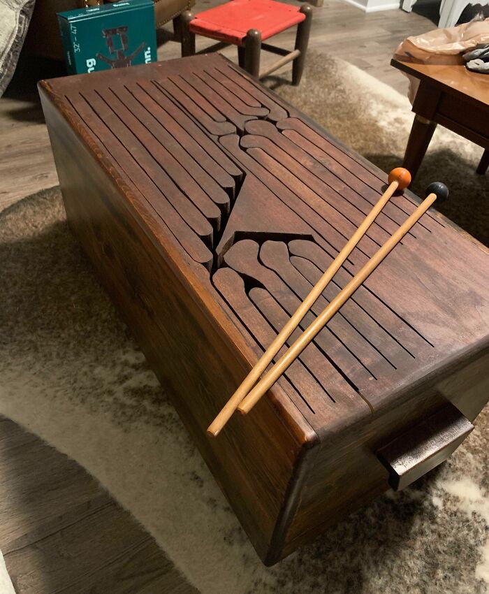 Wooden antique musical instrument with carved keys and two mallets placed on top, found old item with no clue.