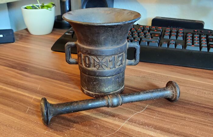 Old metal mortar and pestle on a desk, an example of finding something old with no clue what it is.