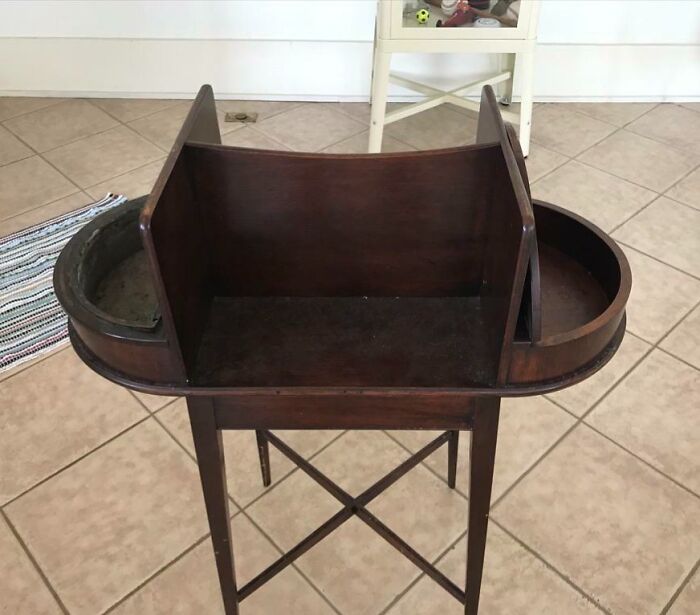 Old wooden object with curved sides and dividers, an example of people finding something old and unknown.