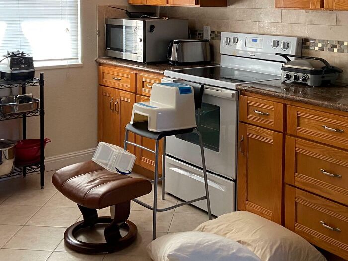 Creative kids invention setup in a kitchen showing IQ 10000000 level DIY project surprising parents.