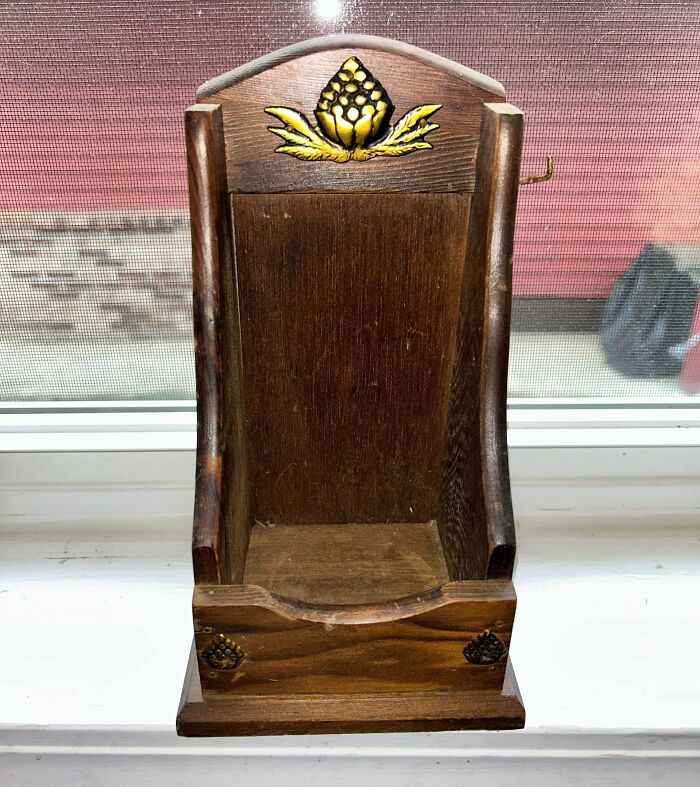 Old wooden container with a decorative flower carving, an example of people finding something old and unknown objects.