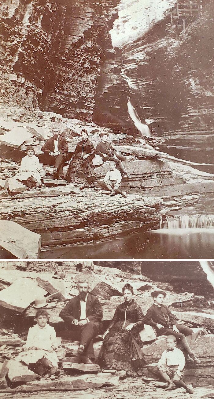 Family in vintage clothing posing on rocky terrain near a waterfall in a vacation pic from before cell phone cameras existed