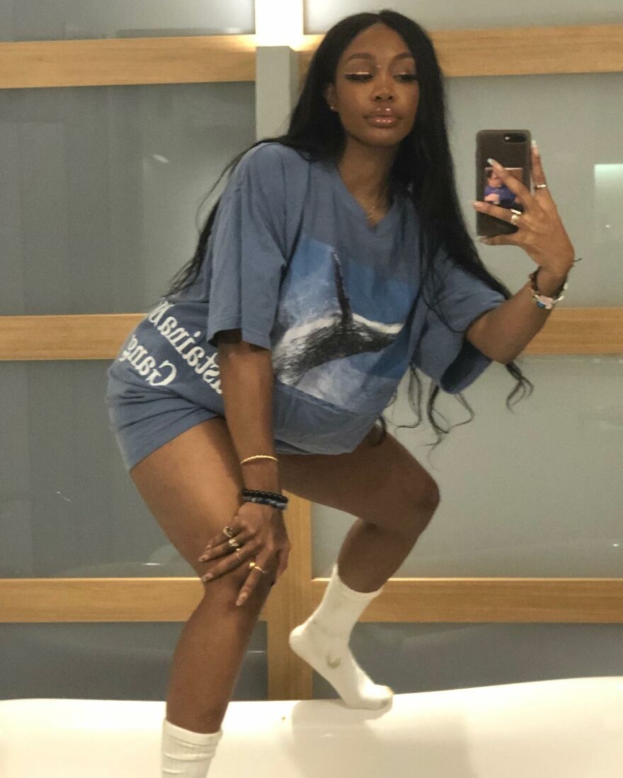 Woman taking a mirror selfie, showcasing cosmetic transformation with confident pose and casual comfortable outfit indoors. Woman taking a mirror selfie, showcasing cosmetic transformation with confident pose and casual comfortable outfit indoors.