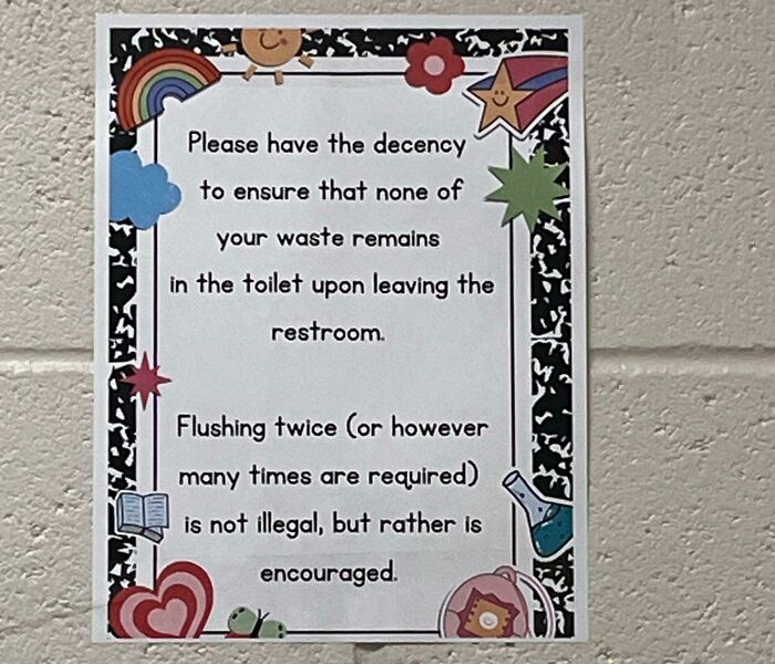 Passive-aggressive coworker note requesting proper toilet flushing decorated with colorful cartoon stickers on office wall.