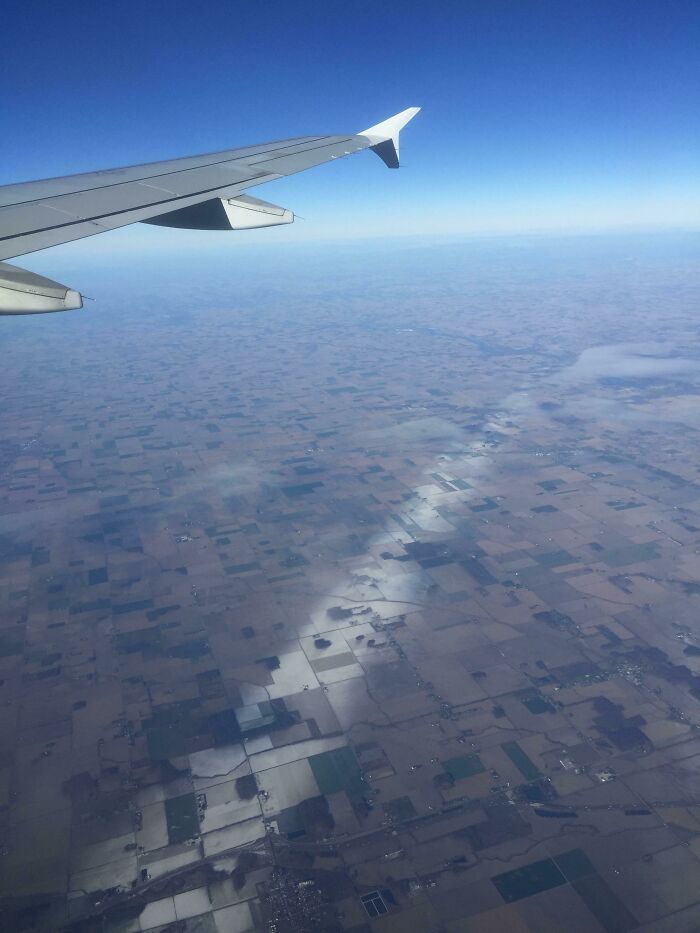 View from airplane wing showing a reflective land pattern that looks unreal in this unphotoshopped pic from sky.