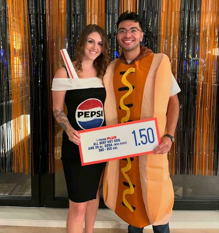 Couple dressed in genius Halloween costumes featuring a Pepsi bottle and a hot dog holding a vintage price sign.