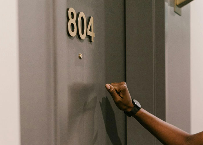 Hand knocking on apartment door number 804 illustrating an incredible coincidence that sounds fake but is true.