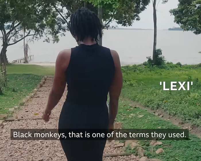 Young woman walking outdoors by a lake, speaking about the horror of Dubai porta potty parties.