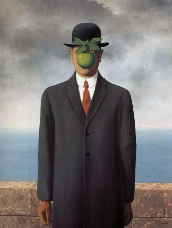Surreal timeless painting of a man in a black coat and bowler hat with a green apple covering his face.