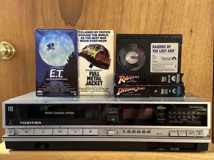 Vintage Toshiba VCR with classic movie VHS tapes, illustrating the next big thing that totally flopped in technology.