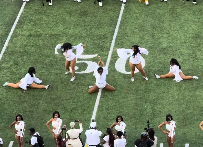Plus-size college dancers perform at halftime on football field, facing bodyshaming comments from announcer and public backlash.