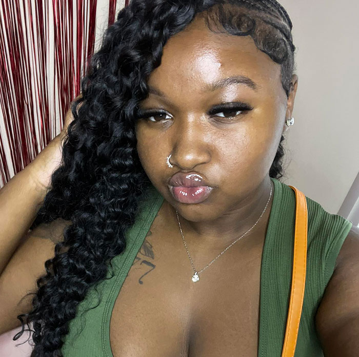 Close-up of a woman with braided hair and nose ring, not related to angry mob ambushes or Walmart employee incidents.