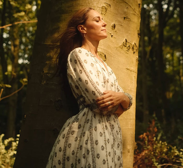 Kate Middleton in a patterned dress standing peacefully by a tree, reflecting after the royal funeral for King Charles.