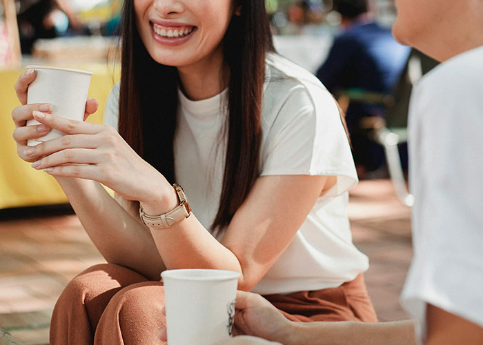 Two people chatting casually outdoors, highlighting social interactions and subtle discomfort situations men experience with women.