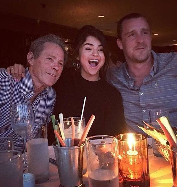 Selena Gomez's mom with friends at a restaurant table lit by candlelight, reacting with laughter and smiles. Selena Gomez's mom with friends at a restaurant table lit by candlelight, reacting with laughter and smiles.