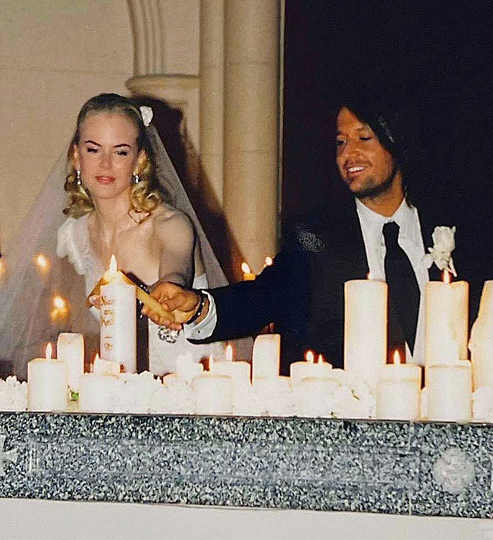 Nicole Kidman and Keith Urban lighting candles together at their wedding ceremony, signaling relationship clues.