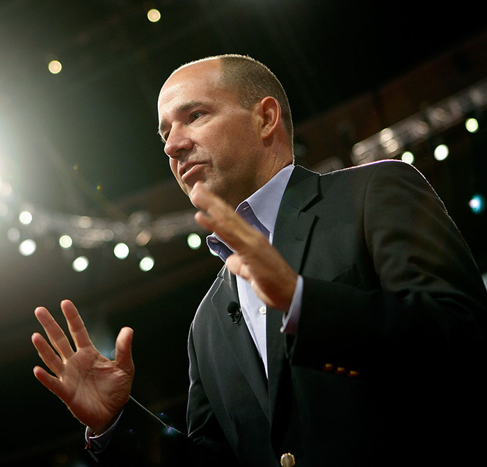 Commentator speaking with hand gestures, wearing a dark blazer, related to unacceptable Charlie Kirk remarks and firing.