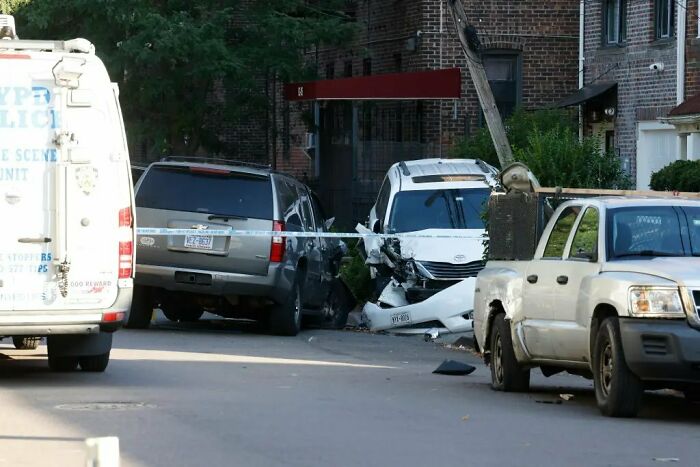 Damaged white car involved in maniac driver incident with NYPD police scene unit van and pickup truck nearby Damaged white car involved in maniac driver incident with NYPD police scene unit van and pickup truck nearby