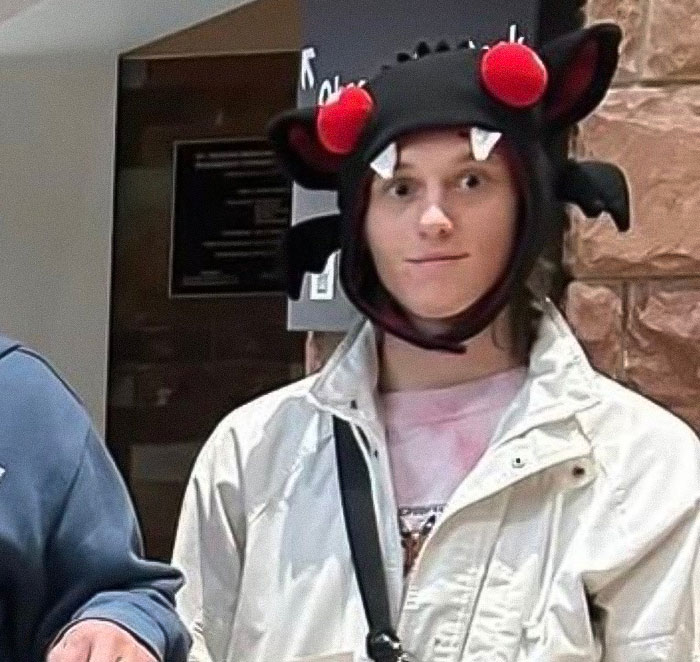 Young person wearing a Halloween hat with red eyes, possibly related to Tyler Robinson's trans partner disappearance story. Young person wearing a Halloween hat with red eyes, possibly related to Tyler Robinson's trans partner disappearance story.