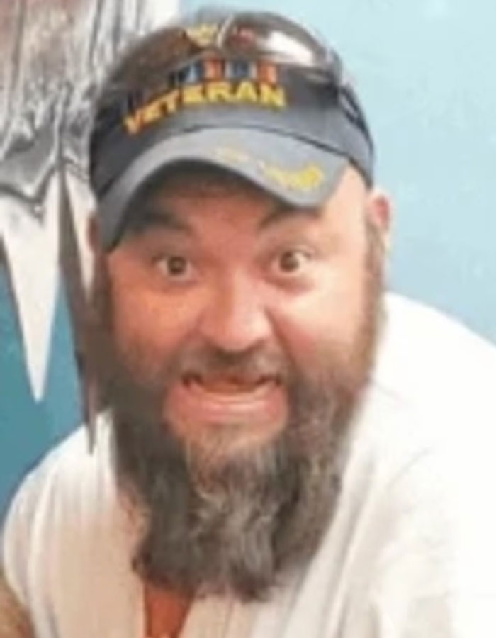 Man wearing a U.S. veteran cap with a beard, related to Michigan suspect's eerie confession before church attack.