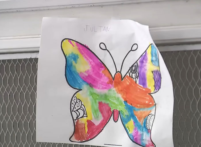Child&rsquo;s colorful butterfly drawing taped to a door, related to American nightmare mom found lifeless at home story.